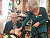 Stock photo waiter serving senior couple eating at vegan restaurant retired man and woman on active elderly