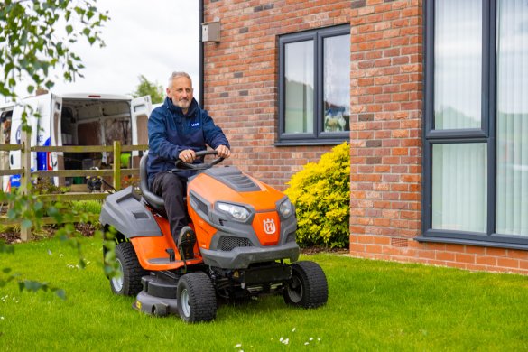 Lace Housing grounds team using a ride on lawnmower