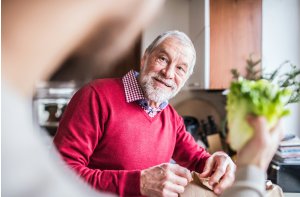Male resident looking at someone holding lettuce