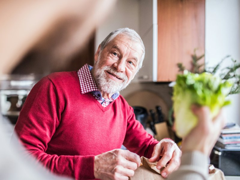 Male resident looking at someone holding lettuce
