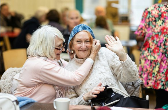 Two female residents smiling in communal area