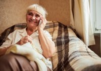 Female resident smiling while on the phone