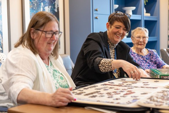 Lace Housing staff doing a jigsaw with a resident