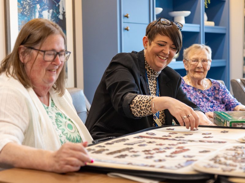Lace Housing staff doing a jigsaw with a resident