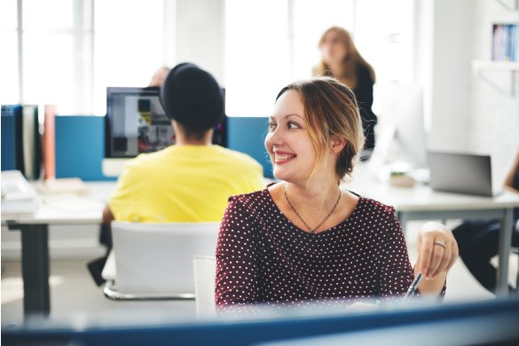 female staff smiling working on the computer