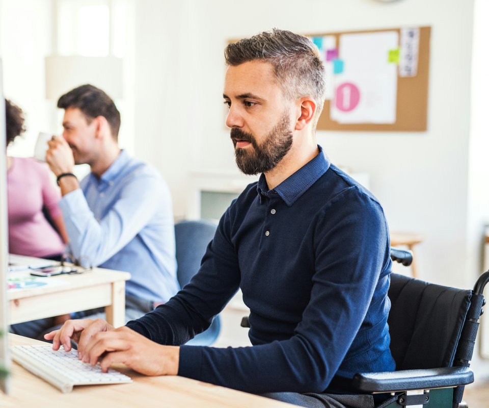 Male staff member working on the computer