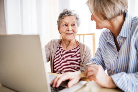 Resident using the computer with support from volunteer